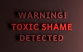 Warning message with words Toxic shame written in bold red letters on red background