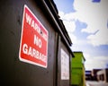 Warning no garbage sign on trash can
