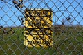 `Warning: No Trespassing` sign in English and Spanish