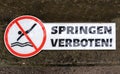 Warning notice sign do not jump pool o river - Warnhinweis mit Verbot ins Wasser zu springen - Springen verboten Royalty Free Stock Photo