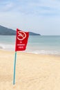 Warning red flag no swimming danger sign on the tropical beach Royalty Free Stock Photo