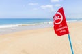 Warning red flag no swimming danger sign on the tropical beach Royalty Free Stock Photo