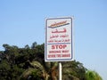 A warning road sign in Arabic and English, Translation of Arabic words ( Stop, Wrong way, Severe Tire Damage ) Royalty Free Stock Photo