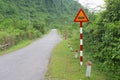 Warning road sign floods jungle mountains, Phong Nha, Vietnam Royalty Free Stock Photo