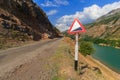 Warning road sign. The landscape of Uzbekistan. Uzbekistan, western Tien-Shan mountains. Royalty Free Stock Photo