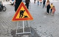 Warning road sign, road works in progress. Yellow-red triangular road sign Close up. Construction site. Road works Royalty Free Stock Photo