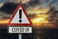 Warning road sign with text COVID-19