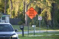 Warning roadworks sign and safety barrier on city street during maintenance repair work Royalty Free Stock Photo