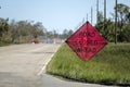 Warning roadworks sign and safety barrier on city street during maintenance repair work Royalty Free Stock Photo