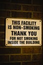 A warning sign announcing that the facility is non-smoking inside, posted to the facility& x27;s brick wall in Chardon, Ohio