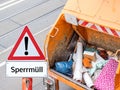 Warning sign bulky garbage with truck in German