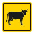 Warning sign for cattle on the road. Silhouette of cow on yellow background Royalty Free Stock Photo