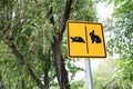 Warning sign cross the road rabbit and turtle in park.