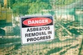 A warning sign Danger Asbestos on a fence at construction site Royalty Free Stock Photo