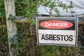 A warning sign Danger Asbestos on a fence at site rehabilitated post asbestos contamination Royalty Free Stock Photo