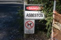 A warning sign Danger Asbestos on a fence at site rehabilitated post asbestos contamination Royalty Free Stock Photo