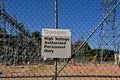 A `Danger` sign in front of a fence of a utility company Royalty Free Stock Photo
