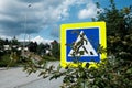 Warning sign: danger on the road. Crossway for pedestrians to walk, zebra signal for drivers. Blue sign with yellow noticeable