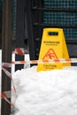 A warning sign about the danger . The yellow information plate reads: \