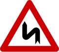 Warning sign with dangerous curves on left