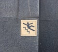warning sign on a dark granite wall, slippery steps, 2 Royalty Free Stock Photo