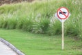 The warning sign do not use vehicle horn with flowering grass ba