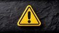 Warning sign with exclamation mark on dark textured background Royalty Free Stock Photo