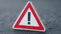 Warning sign with exclamation mark on a textured surface, alerting to caution or danger Royalty Free Stock Photo
