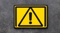 Warning sign with exclamation mark on yellow background for safety alert Royalty Free Stock Photo