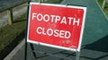 Warning sign and fenced work being carried out on the footpath