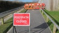 Warning sign and fenced work being carried out on the footpath