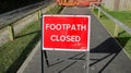 Warning sign and fenced work being carried out on the footpath