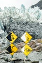 warning sign in franz josef glacier with edge of the glacier in the background, south island new zealand Royalty Free Stock Photo