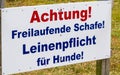 Sign `Freilaufende Schafe. Leinenpflicht fÃÂ¼r Hunde` warn in german about the danger meeting of dog and sheep on the Island Royalty Free Stock Photo