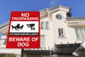 Warning sign in front of a house, protected by CCTV and guard dogs. Security and protection in a residential home concept Royalty Free Stock Photo