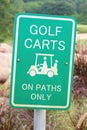 The warning sign of golf carts on paths only, for protecting green grass in golf course. Royalty Free Stock Photo