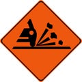 Warning sign with gravel on road