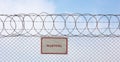 Warning sign hangs on a metal barbed wire fence Royalty Free Stock Photo