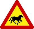 Warning sign with horses on road Royalty Free Stock Photo