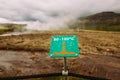 Warning sign of hot earth.Caution of high temperature on golden circle tour near big geyser geothermal area.Steaming boiling water Royalty Free Stock Photo