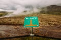 Warning sign of hot earth.Caution of high temperature on golden circle tour near big geyser geothermal area.Steaming boiling water Royalty Free Stock Photo