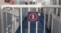 Warning sign icon on metal railings on ships sying no unauthorised access