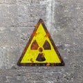 Warning sign indicating the presence of a radioactive area, nuclear site, sign hanging on a wall