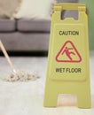 Warning, sign and mop with wet floor for cleaning, service or safety for slip hazard in interior. Icon, danger and board