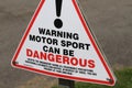 Warning sign for motor racing.