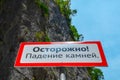 Warning sign in the mountains about the rockfall. Translation from Russian: Caution Falling stones