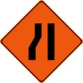 Warning sign with narrow road on left