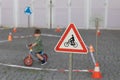 Warning sign near children riding bikes. Royalty Free Stock Photo