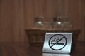 Warning sign. no smoking on the table in the room. Iron plate on the table does not smoke close-up. horizontal view