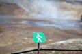 Warning sign of not crossing over rope fence. Big geyser. Geothermal area Royalty Free Stock Photo